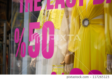 Large Sale text letters on red background on clothing store . 117265123