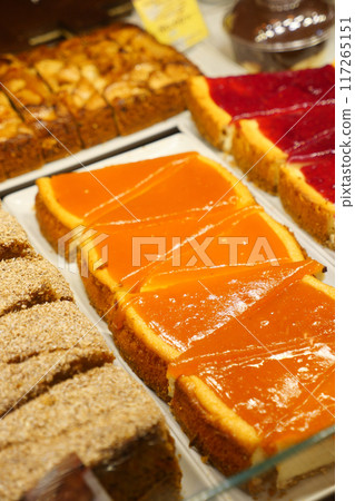 An array of baked goods, including pastries, is showcased in the bakery 117265151