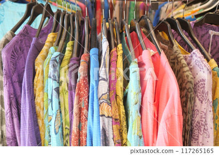 A store with a chic and neat shopping experience featuring stylish clothing on display 117265165
