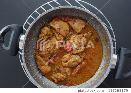 Chicken curry or masala in a bowl on table Chicken curry or masala in a bowl on table 117265179