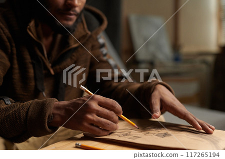 Sketching Ideas on Paper in Art Studio Setting 117265194