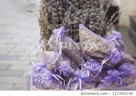 A stack of purple lavender bags fills the basket, creating a beautiful pattern 117265256