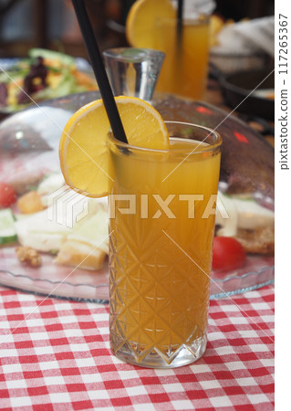 A Refreshing Citrus Drink with an Attractive Garnish Served on a Charming Picnic Table A Refreshing Citrus Drink with an Attractive Garnish Served on a Charming Picnic Table 117265367