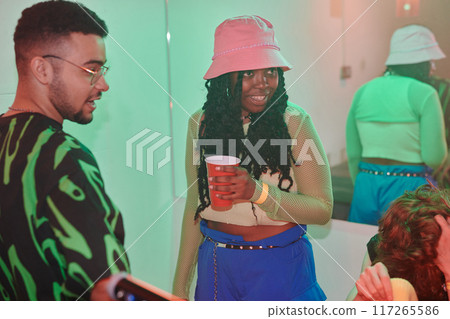 Girl having soda and looking at friend 117265586