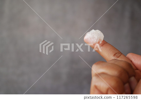 Close up of man hand using petroleum jelly 117265598