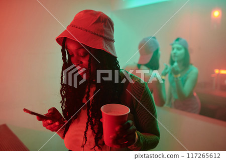Funky girl texting in smartphone 117265612