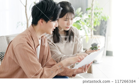 A couple considering the layout of their house A couple considering the layout of their house 117266384