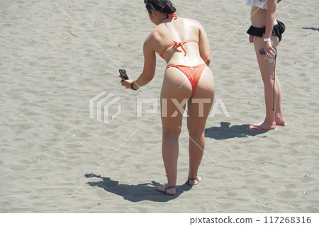 Micro bikini girls playing on the beach, summer scenery 117268316