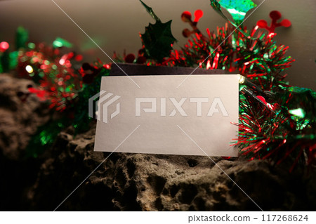 blank christmas greeting card on a background of red and green garland 117268624
