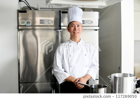 Young asian male chef preparing food in the kitchen 117269050
