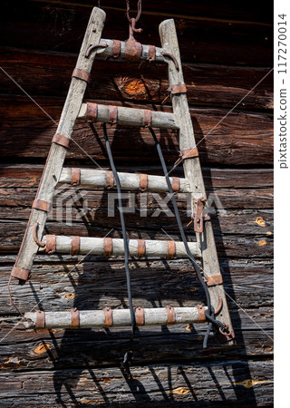 Decoration. Vintage things. A wooden harrow on wall of old wooden house. Decoration. Vintage things. A wooden harrow on wall of old wooden house. 117270014