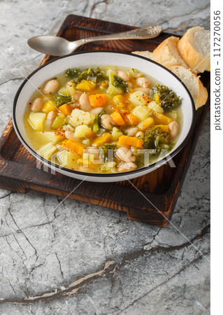 Zuppa Frantoiana Bean and Vegetable Soup closeup on the bowl. Vertical 117270056