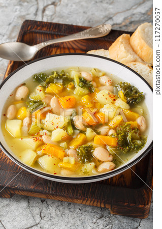 Zuppa Frantoiana italian bean soup with pumpkin and vegetables closeup on the bowl. Vertical Zuppa Frantoiana italian bean soup with pumpkin and vegetables closeup on the bowl. Vertical 117270057