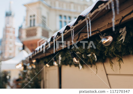 Christmas market stall with Christmas decorations and lights. Crystal Icicle on the Roof 117270347