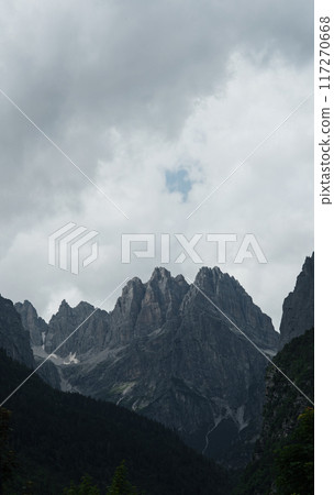Rocky peaks of the Italian Dolomites surrounded by clouds before a storm. 117270668