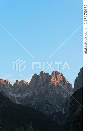 Rocky peaks of the Italian Dolomites in the morning rays of the rising sun. Rocky peaks of the Italian Dolomites in the morning rays of the rising sun. 117270672