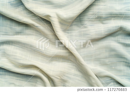 Close-up view of white fabric with subtle pattern. Fabric has slightly wrinkled texture, adding depth and dimension. Blurred background draws focus to fabric as main subject. Close-up view of white fabric with subtle pattern. Fabric has slightly wrinkled texture, adding depth and dimension. Blurred background draws focus to fabric as main subject. 117270883