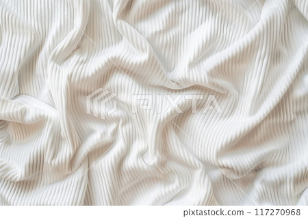 White fabric with crinkled texture folded in half reveals intricate pattern. Center stage against blurred background. Suitable for fashion and textile industries, product photography. 117270968