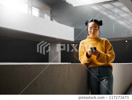 Woman, phone and texting in office building, relax and calm while on internet, search and reading. Asian, girl and business entrepreneur with smartphone for research, office space or idea in Japan 117271673