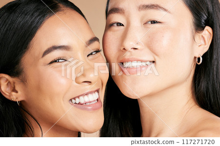 Skincare, cosmetics and portrait of women with makeup isolated on a studio background. Smile, dermatology and face of model friends with happiness for foundation shade diversity on a backdrop Skincare, cosmetics and portrait of women with makeup isolated on a studio background. Smile, dermatology and face of model friends with happiness for foundation shade diversity on a backdrop 117271720
