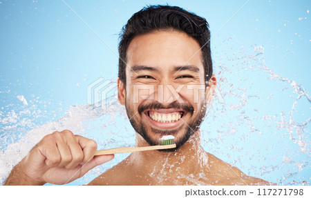 Water splash, portrait or man brushing teeth in studio with toothbrush for white teeth or oral healthcare. Face, tooth paste or happy person cleaning or washing mouth with a healthy dental smile 117271798