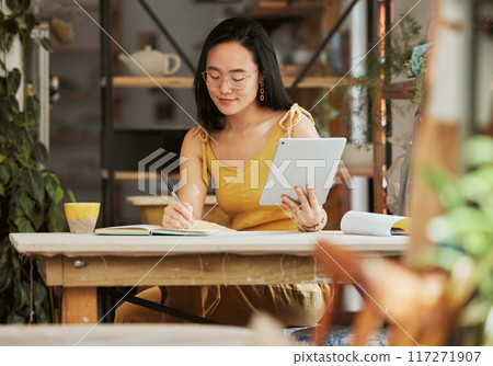 Thinking, research and tablet with asian woman writing in notebook in startup for management, planning or goals. Idea, vision and creative with small business owner for branding, agenda or web design Thinking, research and tablet with asian woman writing in notebook in startup for management, planning or goals. Idea, vision and creative with small business owner for branding, agenda or web design 117271907
