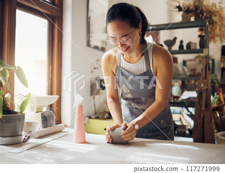 Happy, pottery and woman in workshop with clay for creativity, inspiration and art process. Creative asian small business girl working at artistic workspace with excited smile in Tokyo, Japan 117271999