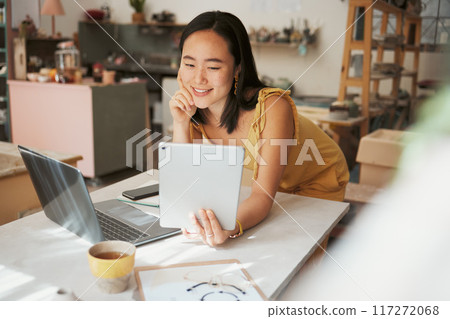 Tablet, e commerce and woman or small business owner smile for profit, sales and startup loan for investment. Online banking, success and asian person, entrepreneur or creative worker check savings 117272068
