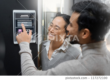 Smart home technology, wall system and couple with digital screen for room lighting, safety security network or house automation. AI software app, ui control panel and Asian people with IOT dashboard Smart home technology, wall system and couple with digital screen for room lighting, safety security network or house automation. AI software app, ui control panel and Asian people with IOT dashboard 117272100