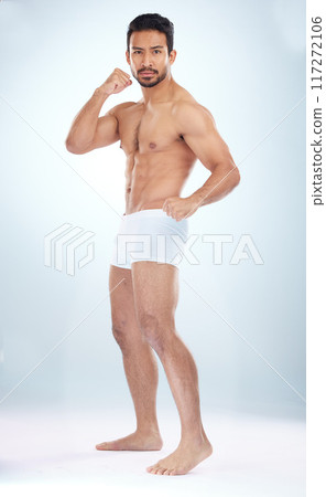 Fitness, underwear body and man with fist, studio or martial arts for muscle, wellness or strong by backdrop. Model, mma and shirtless for balance, posture or portrait by studio background with focus 117272106