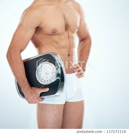 Man in underwear with a scale in studio for fitness goals, mission or motivation on white background. Mockup space, mindset or healthy athlete model body training, workout or exercise to lose weight Man in underwear with a scale in studio for fitness goals, mission or motivation on white background. Mockup space, mindset or healthy athlete model body training, workout or exercise to lose weight 117272118