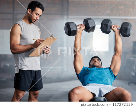 Fitness, body builder and weight, coach or personal trainer with checklist, exercise or training in gym with motivation. Man coaching, workout or bodybuilder with muscle, strong or athlete commitment Fitness, body builder and weight, coach or personal trainer with checklist, exercise or training in gym with motivation. Man coaching, workout or bodybuilder with muscle, strong or athlete commitment 117272139