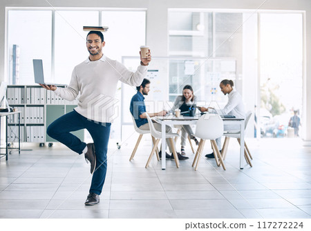 Business man, balance and multitask with laptop, book and coffee in hand while happy about workflow management in a marketing office. Portrait of employee mindset and mental health to study and work 117272224