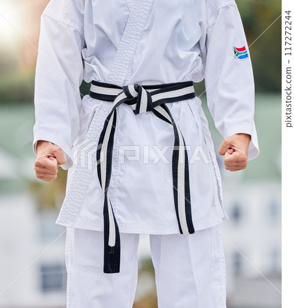 Karate, fitness and body of woman in martial arts training for competition with hands fist, fight and commitment in Japanese culture. Power, challenge and energy of sports person in taekwondo contest Karate, fitness and body of woman in martial arts training for competition with hands fist, fight and commitment in Japanese culture. Power, challenge and energy of sports person in taekwondo contest 117272244
