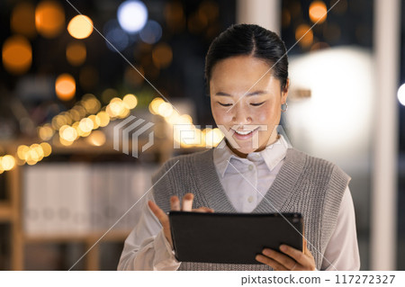 Tablet, night and asian business woman in office for overtime, management and communication. Digital, technology and internet with employee search for corporate, planning and analytics 117272327