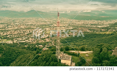 Aerial orbiting shot of a major television and mobile network tower with many antennas close to Grenoble, French Alps 117272341