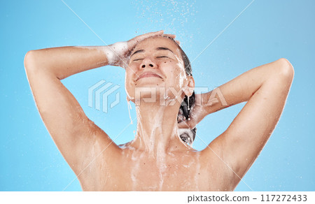 Beauty, hair and woman in shower happy on blue background, haircare and hygiene routine in the morning. Model in water with shampoo foam, cleaning hair with running water for clean fresh lifestyle. 117272433
