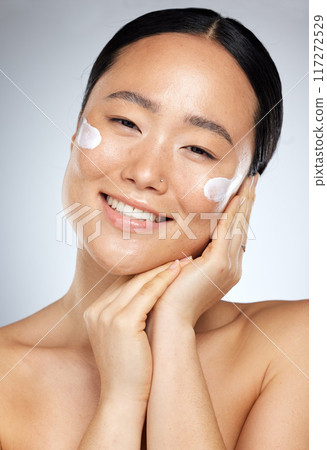 Skincare, beauty and Asian woman with cream on face, smiling in studio on white background. Wellness, skincare products and portrait of happy girl with sunscreen, lotion and beauty product for facial Skincare, beauty and Asian woman with cream on face, smiling in studio on white background. Wellness, skincare products and portrait of happy girl with sunscreen, lotion and beauty product for facial 117272529