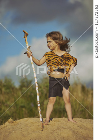 Cute baby dressed in the clothes of primitive people 117272562