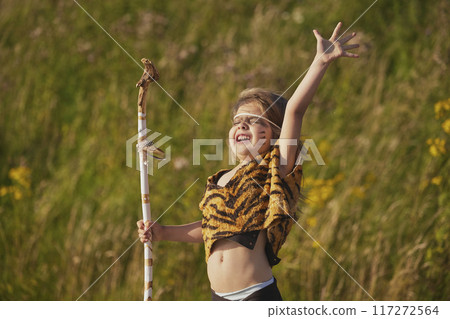 Cute baby dressed in the clothes of primitive people 117272564
