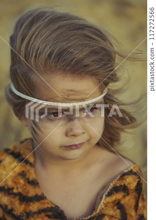 Cute baby dressed in the clothes of primitive people 117272566