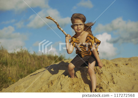 Cute baby dressed in the clothes of primitive people 117272568