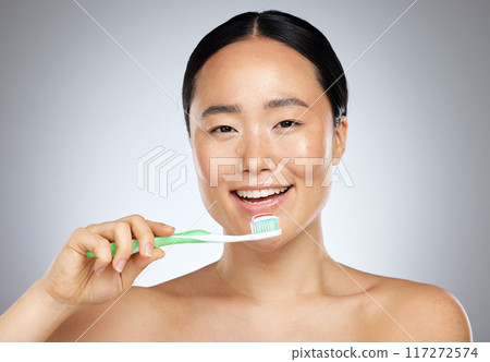 Brushing teeth, asian woman beauty and dental wellness, health and cleaning cosmetics on studio background. Happy young Japanese model face portrait, toothpaste on toothbrush and healthy mouth breath Brushing teeth, asian woman beauty and dental wellness, health and cleaning cosmetics on studio background. Happy young Japanese model face portrait, toothpaste on toothbrush and healthy mouth breath 117272574