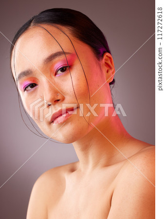 Face, makeup and beauty with a model asian woman in studio on a gray background to promote cosmetics. Portrait, natural and confident with an attractive young female posing for a cosmetic product 117272618