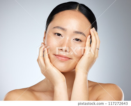Skincare, beauty and woman with facial wellness against a grey mockup studio background. Face portrait of a young, Asian and happy model with luxury cosmetics from dermatology and mock up space 117272643