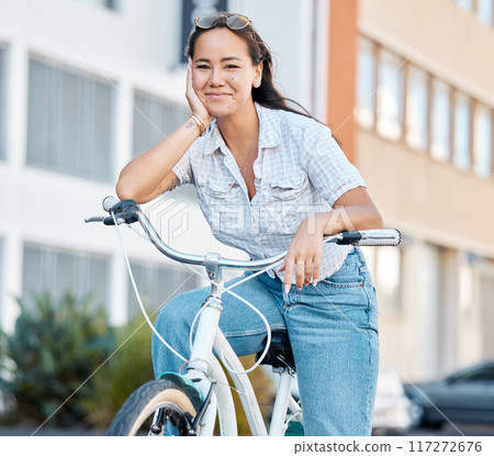 Bike, travel and city with a woman tourist riding her bicycle in a town for sightseeing or commuting. Cycling, carbon footprint and traveling with a young female enjoying tourism and adventure Bike, travel and city with a woman tourist riding her bicycle in a town for sightseeing or commuting. Cycling, carbon footprint and traveling with a young female enjoying tourism and adventure 117272676
