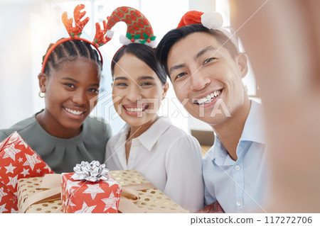 Christmas, selfie and business people with gift for giving, love and celebration with holiday office party or workplace culture and diversity. Corporate staff in portrait pov picture with present box 117272706