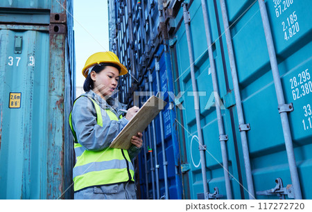 Shipping, cargo and stock container with woman reading checklist for ecommerce delivery logistics at warehouse. Supply chain, distribution and industrial management by asian manager at a factory 117272720