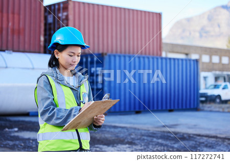 Logistics, inspection and worker working on shipping of delivery at an outdoor warehouse or port. Asian industrial employee writing notes and inventory while working in the supply chain business 117272741