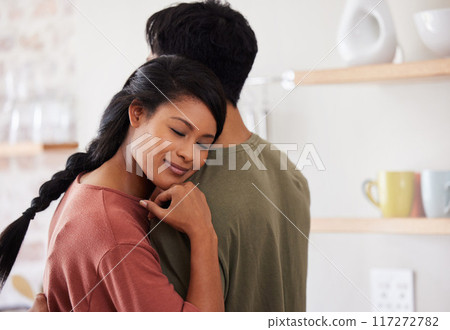 Hug, support and couple with love in their marriage in the kitchen together in their house. Young, happy and relax man and woman hugging for comfort, affection and happiness in their home with smile Hug, support and couple with love in their marriage in the kitchen together in their house. Young, happy and relax man and woman hugging for comfort, affection and happiness in their home with smile 117272782
